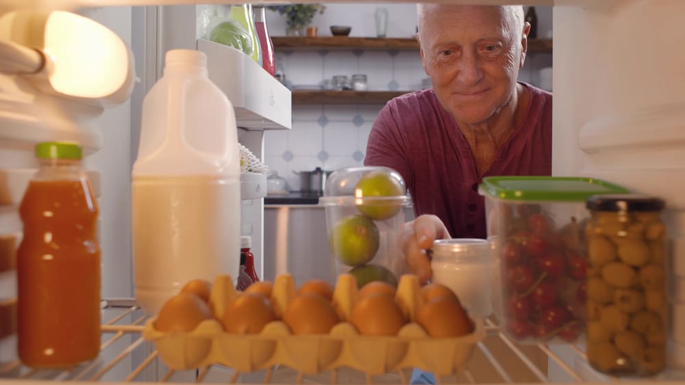 View,From,Fridge,Of,Senior,Man,Unpacking,Paper,Bags,With