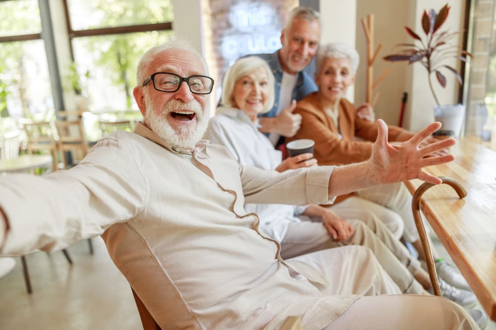 Joyful,Senior,Man,Spending,Time,With,Friends,Stock,Photo